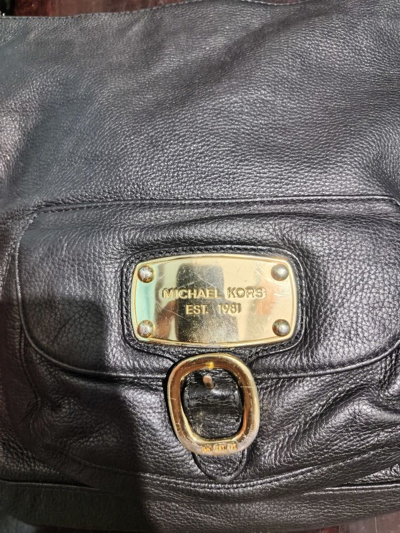 Michael Kors Black Leather Hobo Bag (Category: Luxury Bags & Wallets) located in Manila. Submitted by dyastenthrift (Listing ID 1449271239, Image 2). Description: - Authentic Michael Kors black leather hobo bag - Elegant gold hardware details - Convenient front pocket with buckle closure - Secure top zipper closure - Spacious interior with branded tag - Ideal for daily use.