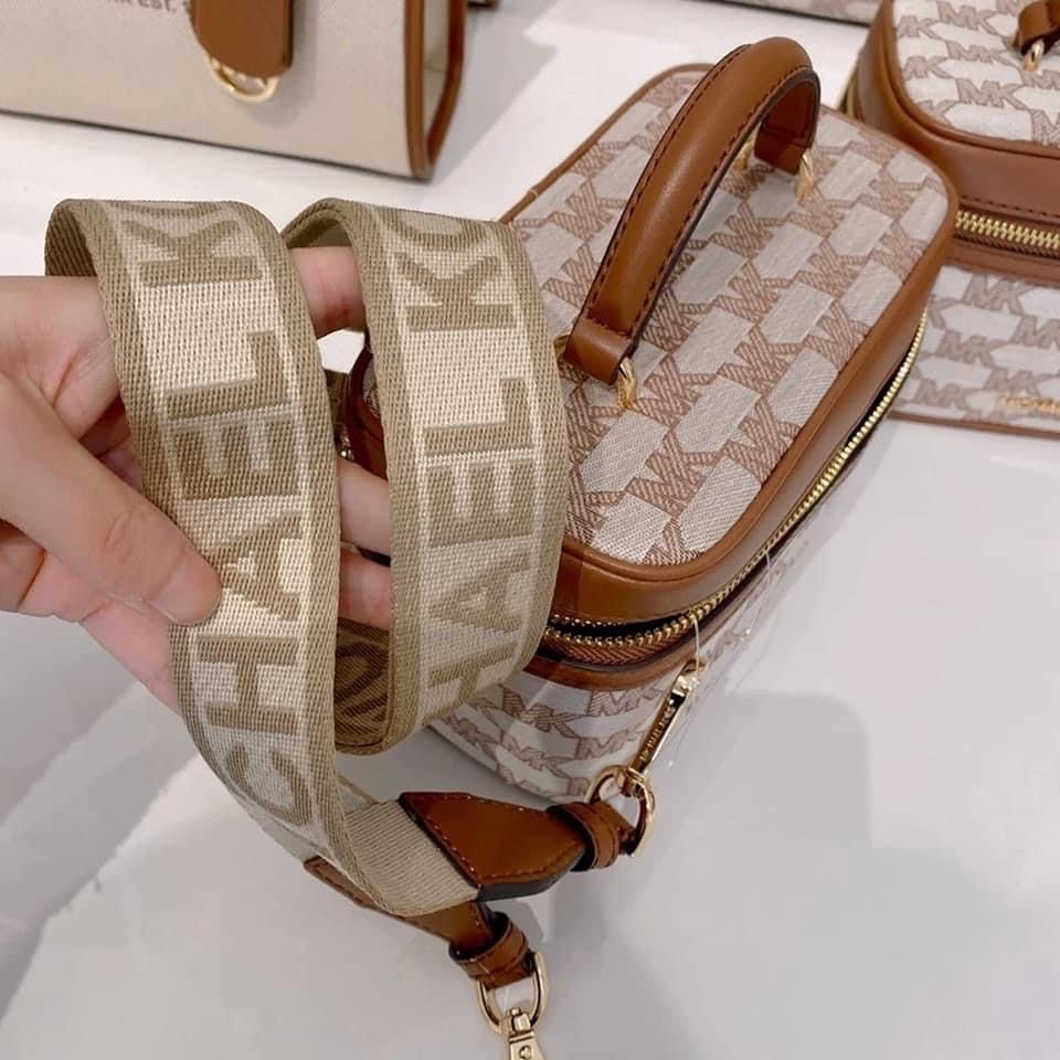 Michael Kors MK Signature Vanity Bag (Category: Luxury Bags & Wallets) located in Makati City. Submitted by tinajuancho (Listing ID 1449322547, Image 3). Description: - Authentic Michael Kors vanity case - Signature MK print with tan leather trim and handle - Secure zipper closure - Spacious main compartment - Interior zippered pocket for organization - Detachable crossbody strap for versatile wear - Ideal for travel or everyday makeup storage.