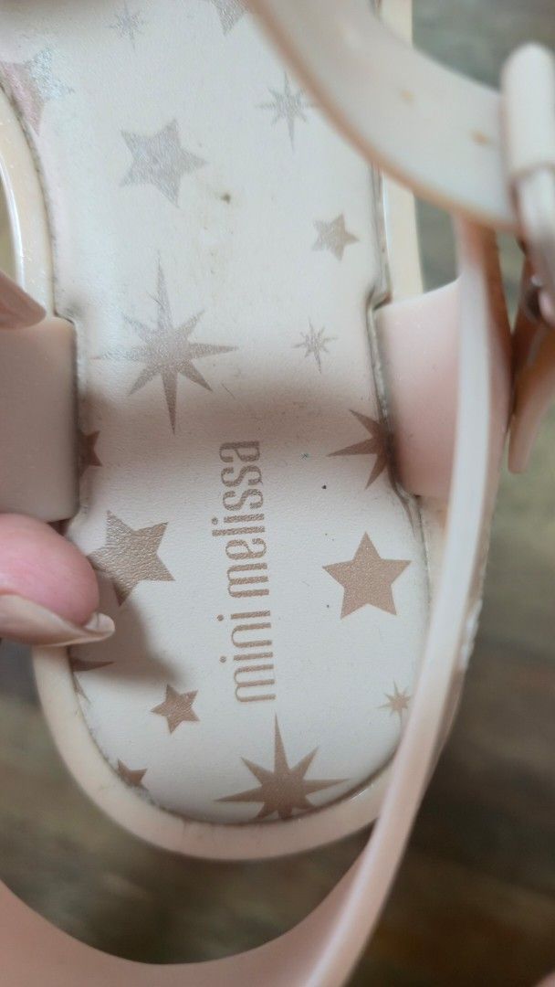 Mini Melissa Pink Star Jelly Sandals (Category: Babies & Kids Fashion) located in Quezon City. Submitted by mimi0024 (Listing ID 1449127661, Image 2). Description: size: USA 4 - Adorable pink jelly sandals from Mini Melissa. - Features a fun star pattern on the insoles. - Decorated with a charming bow and star detail on the strap. - Secure buckle closure for a comfortable fit. - Perfect for little fashionistas! - Minor signs of wear on the soles.