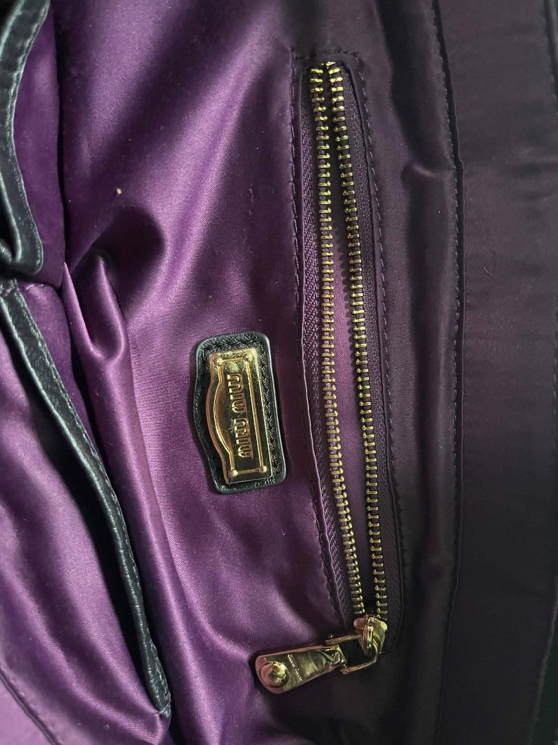 Miu Miu Black Leather Quilted Handbag (Category: Luxury Bags & Wallets) located in Abucay. Submitted by chinithou (Listing ID 1449327182, Image 3). Description: - Miu Miu black leather handbag - Stylish quilted design - Elegant gold hardware accents - Luxurious purple satin interior lining - Convenient interior zippered pocket - Comfortable black leather handles with gold ring details - Ideal for everyday chic and versatile use.
