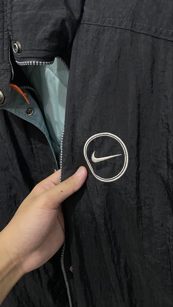 Nike Black Jacket with Large "NIKE" Logo on Back (Category: Coats, Jackets and Outerwear) located in Porac. Submitted by moethrifter (Listing ID 1449167055, Image 3). Description: - Classic black Nike jacket - Bold "NIKE" logo across the back - Embroidered Nike swoosh on the chest - Easy snap button closure - Comfortable light blue inner lining - Proudly made in the Philippines.
