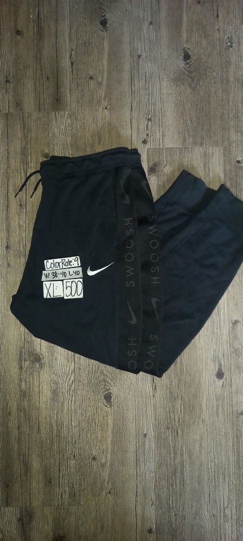 Nike Swoosh Jogger Pants Black (Category: Joggers) located in Imus. Submitted by pampie (Listing ID 1449149202, Image 1). Description: - Black Nike Joggers - Size: XL - Features adjustable drawstring waist - Nike Swoosh branding on waistband and side - Material: 80% Cotton, 20% Polyester - Made in China - Ideal for workouts and casual wear.