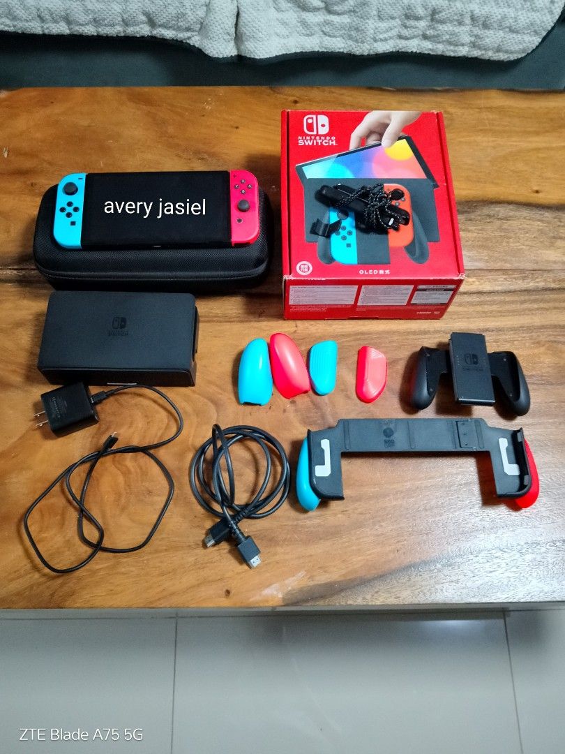 Nintendo Switch Oled Complete + Extra Accessories (Category: Nintendo) located in Manila. Submitted by averyjasiel (Listing ID 1449125978, Image 1). Description: Nintendo Switch Oled (Complete W/ extra accessories) Inclusions: •unit •joycons •dock •hdmi •charger •skull & co case •skull & co neo grip with 3 sets of interchangeable grip styles •box •joycon rail straps •joycon grip Valenzuela location for meetup (sm val, sm gc, etc) Can do delivery 