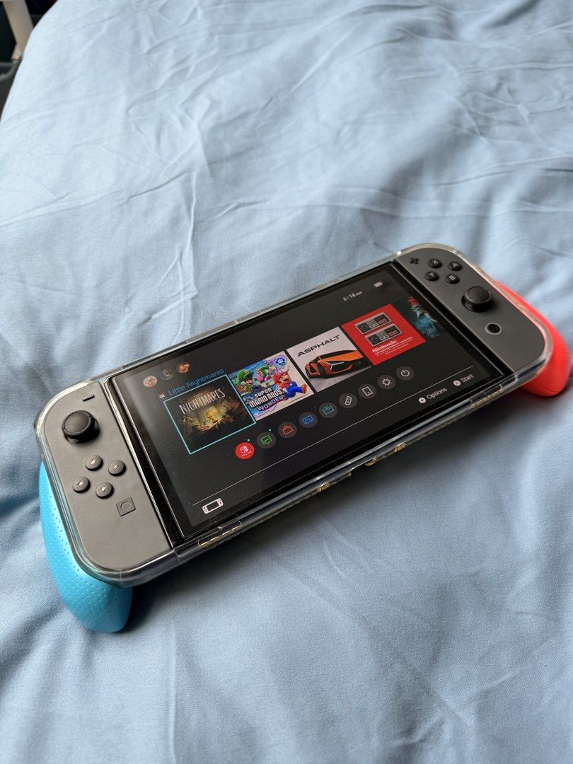 Nintendo Switch OLED with Clear Case and Joy-Cons (Category: Nintendo) located in Manila. Submitted by khloejesy (Listing ID 1449108491, Image 2). Description: - Nintendo Switch - Includes red and blue Joy-Cons - Comes with a clear protective case - Screen is on and functional - Ready for immediate gaming.