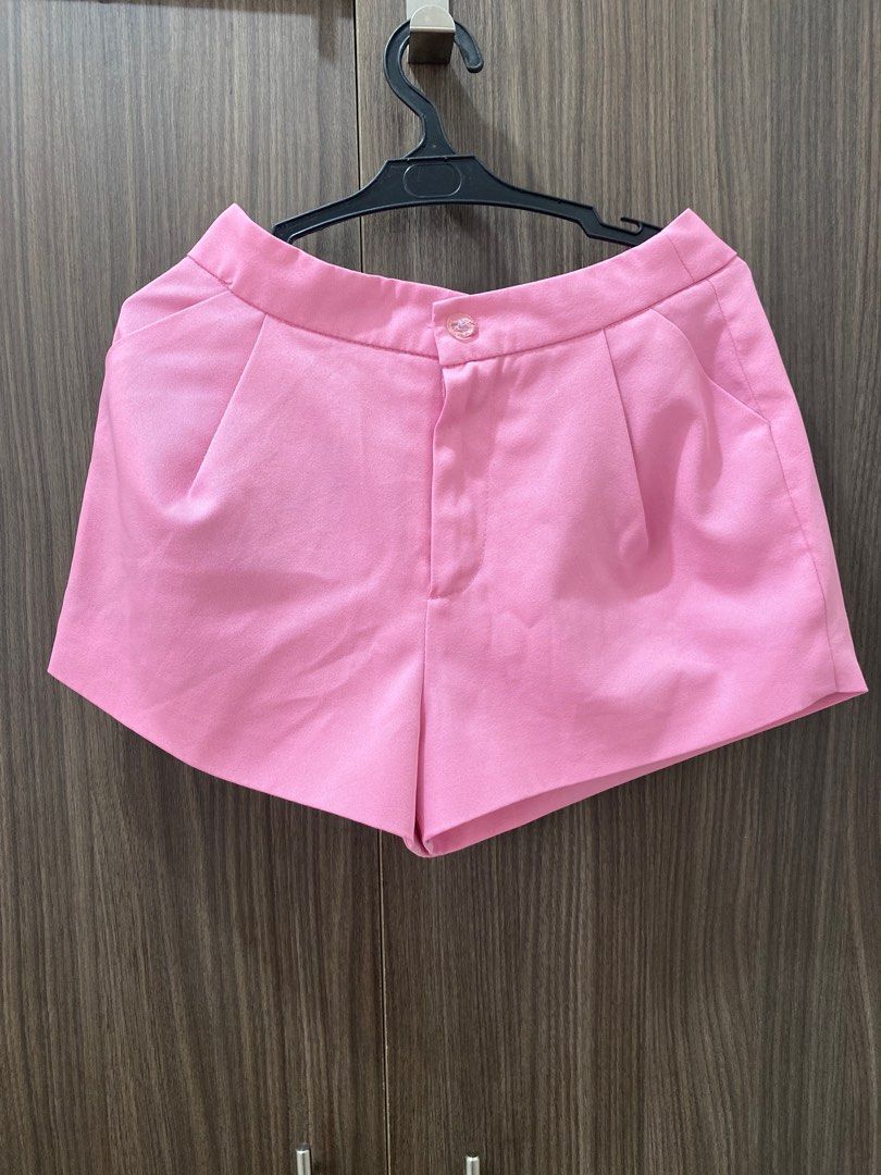 Pink Pleated High-Waisted Shorts (Category: Shorts) located in Mandaluyong City. Submitted by preLAVed (Listing ID 1449192828, Image 1). Description: - Cute pink shorts - Front pleats for a tailored look - Functional side pockets - Secure button and zip closure - Versatile for casual or dressed-up outfits.