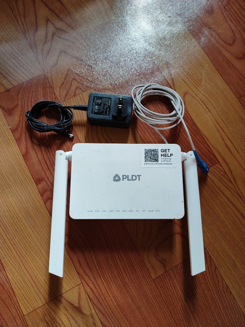 PLDT White WiFi Router with Power Adapter and Cable (Category: Networking) located in Manila. Submitted by kuyawew (Listing ID 1449146498, Image 1). Description: - PLDT WiFi Router - Includes original power adapter and cable - Equipped with antennas for enhanced signal strength - Tested and confirmed working - Ready to set up your home network no issue.
