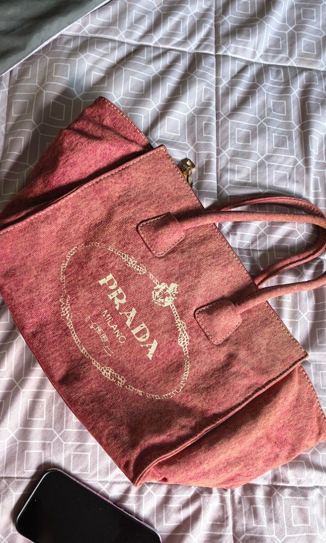 Prada canapa tote (denim like) (Category: Bags & Wallets) located in Nusajaya. Submitted by emmajani (Listing ID 1449106950, Image 2). Description: denim material got from a thrift reseller in great condition lampo zipper in pink-peach color can fit bottle, ipad, macbook, books etc suitable for moms, or for working bag lightweight. super easy to bring anywhere..