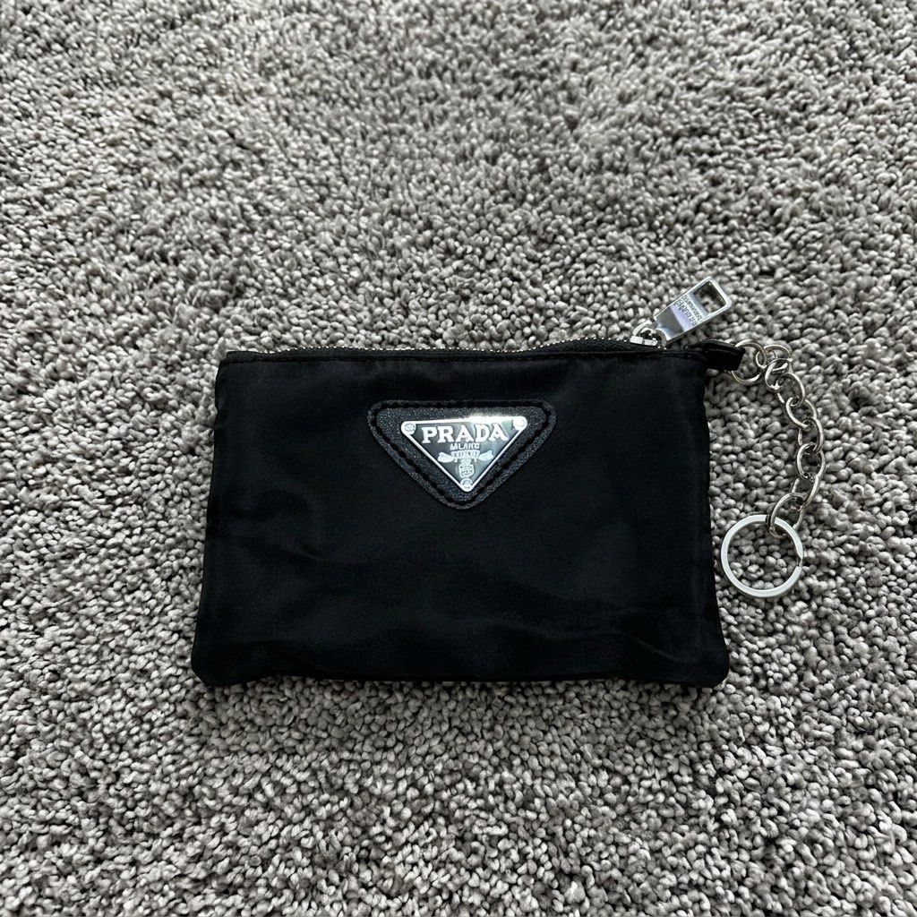 PRADA Nylon Mini Pouch Keychain | PRE-ORDER (Category: Luxury Bags & Wallets) located in Manila. Submitted by thegwpvault (Listing ID 1449182018, Image 1). Description: ✨ PRE-ORDER ONLY A sleek and stylish mini nylon pouch with a keychain attachment—perfect for coins, earbuds, lip balm, cards, or small everyday essentials. Inclusions: • Prada Nylon Mini Pouch Keychain • Prada Presentation Box • Certificate/Tag (as shown) 📦 Condition: Brand New �