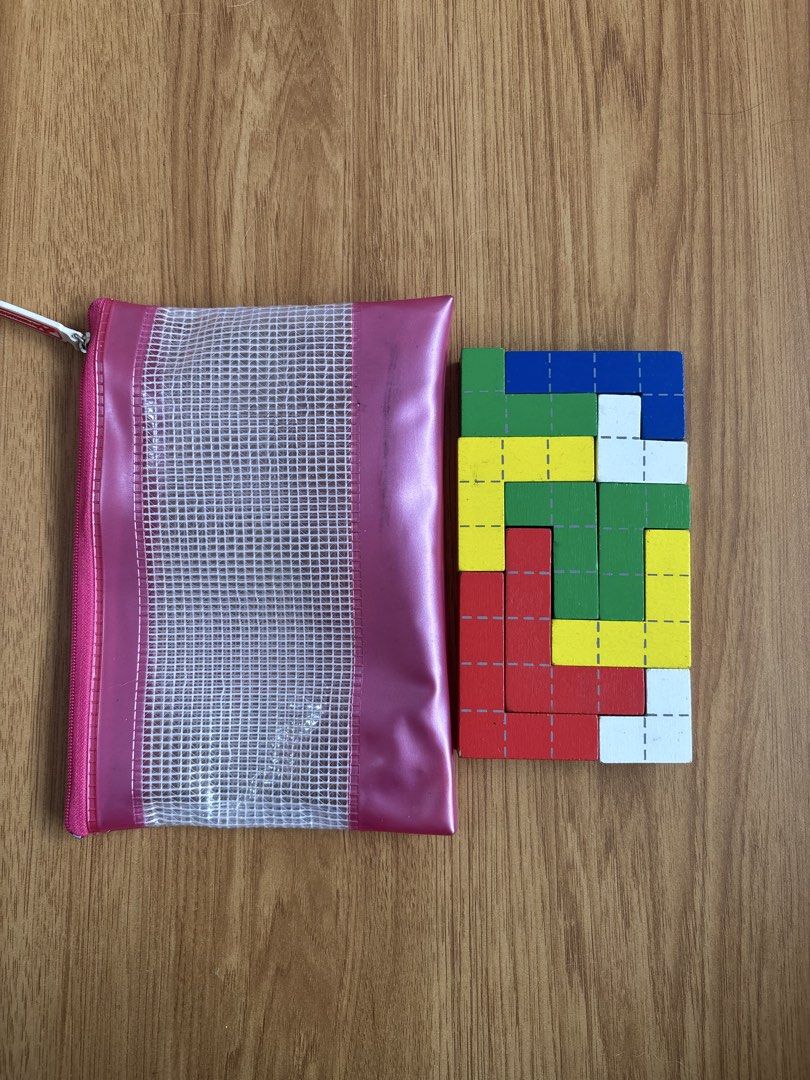 Preloved Wooden Geometric Puzzle Blocks with Storage Pouch (Category: Educational & Learning Toys) located in Bulacan. Submitted by lmsdeclutteringcorner (Listing ID 1449111449, Image 1). Description: - Fun geometric puzzle blocks for kids - Includes a pink zippered pouch for easy storage and carrying - Colorful blocks with grid lines - Develops spatial reasoning and problem-solving skills - Ideal for playtime and learning -Kindly expect sign of 