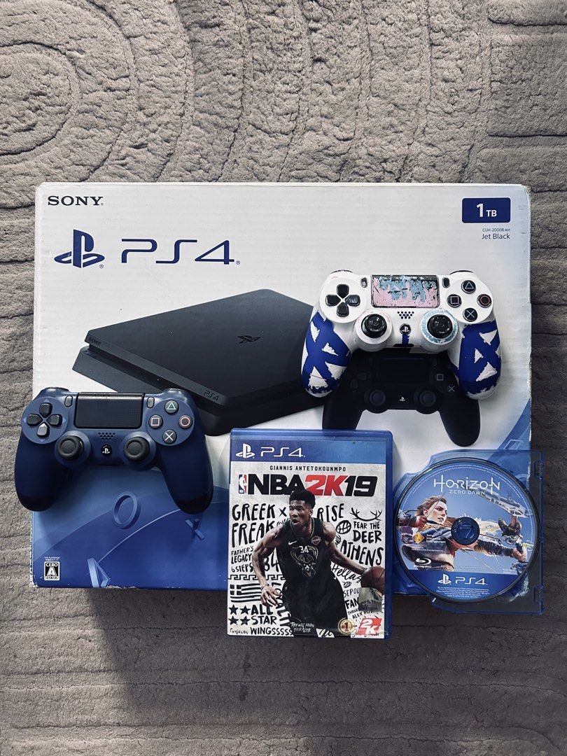 PS4 SLIM 1 TB (Category: PlayStation) located in Manila. Submitted by zavgamingshop (Listing ID 1449143291, Image 1). Description: PS4 Slim 1TB Black (CUH-2218B) Premium Complete Set • 2 V2 Controller • 2 Physical Games • Complete Cables & Original Box • With Warranty • LATEST FIRMWARE Smooth Performance • Excellent Condition • Plug & Play 📍 Valenzuela Cash on Delivery Available.