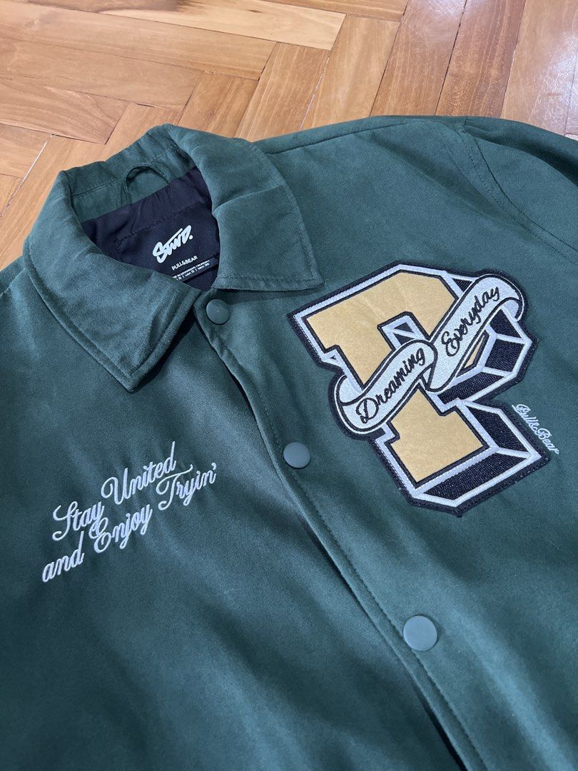 Pull & Bear Varsity Jacket (Category: Coats, Jackets and Outerwear) located in Kuala Lumpur. Submitted by afiqdnn (Listing ID 1449125587, Image 3). Description: condition: 10/10 💯 - Size S (Pit: 23inch, Length: 26inch) - Embroidered patches and text - Faux Suede - Ribbed cuffs and hem - Button-up closure - Two side pockets.