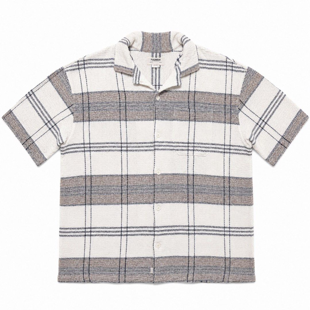 Pull & Bear Plaid Knitted Short Sleeve Polo Shirt (Category: Tshirts & Polo Shirts ) located in Manila. Submitted by flowww2121 (Listing ID 1449109289, Image 1). Description: - Brand: Pull & Bear - Type: Short sleeve shirt - Pattern: Classic plaid (cream, brown, blue) - Features: Button-up front, collar - Origin: Made in India - Size: Medium (M) - heavy knitted - used once nung nag siargao lang - bought if for 2k+ sa pull & bear SM Megamall Overs