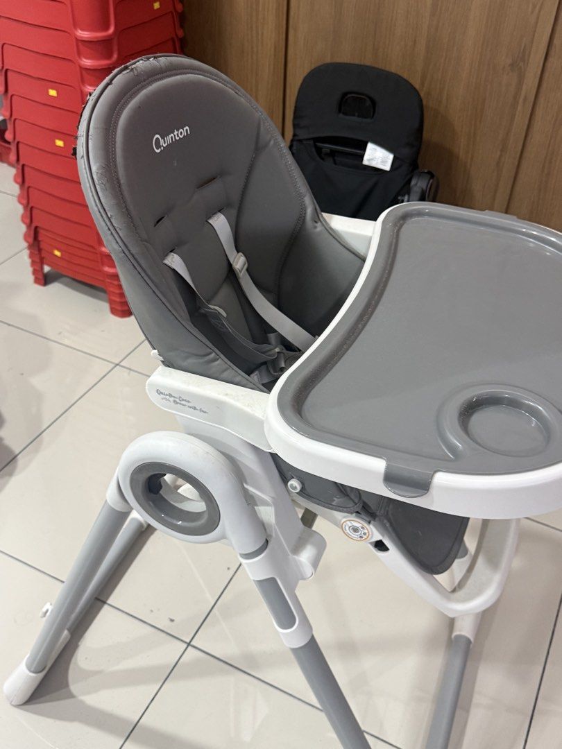 Quinton High Chair - Adjustable, Foldable (Category: Baby High Chairs) located in Kuala Lumpur. Submitted by fahmisipoot (Listing ID 1449149388, Image 1). Description: - Quinton high chair in grey - Removable tray with built-in cup holder - Safety straps included - Adjustable legs for customized height - Folds flat for easy storage - Some wear on seat padding (visible in photos) - Fully functional and safe to use.