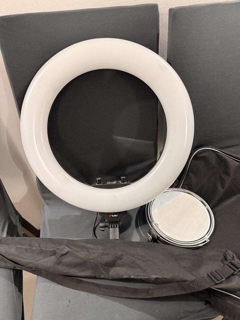 R48L 18" Ring Light with Stand,Mirror and Bag (Category: Lighting & Studio Equipment) located in San Fernando. Submitted by prelovedbymiho (Listing ID 1449186990, Image 1). Description: - White circular ring light for bright, even illumination. - Includes a round, mirror attachment. - Comes with a black carrying bag with straps for easy transport. - Ideal for content creators, photographers, and anyone needing professional lighting. Adjustable Wa