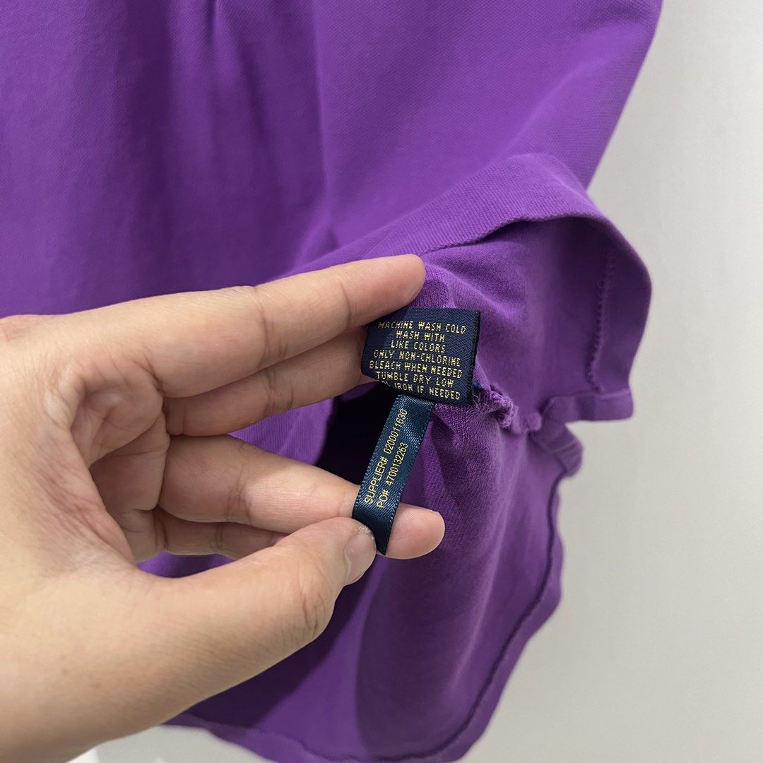 Ralph Lauren Polo Shirt (Category: Others Tops) located in Makati City. Submitted by declutterfindsph (Listing ID 1449142363, Image 3). Description: - Authentic Ralph Lauren Polo Shirt - Color: Purple - Size: Large on tag - 17 W x 23 L -Good condition - Classic polo design with buttoned neckline - Features iconic green polo player logo on chest - Made in Nicaragua - Perfect for casual outings and everyday wear Location : Ayala Homes, Mandaluyong.
