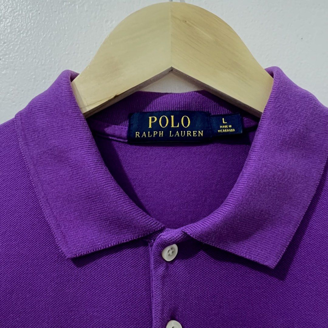 Ralph Lauren Polo Shirt (Category: Others Tops) located in Makati City. Submitted by declutterfindsph (Listing ID 1449142363, Image 2). Description: - Authentic Ralph Lauren Polo Shirt - Color: Purple - Size: Large on tag - 17 W x 23 L -Good condition - Classic polo design with buttoned neckline - Features iconic green polo player logo on chest - Made in Nicaragua - Perfect for casual outings and everyday wear Location : Ayala Homes, Mandaluyong.