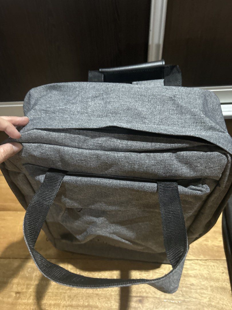 Rudy Project Grey Backpack with Multiple Compartments (Category: Backpacks) located in Manila. Submitted by Declutterland (Listing ID 1449282263, Image 3). Description: - Stylish grey backpack with black accents. - Main compartment with securing straps for your belongings. - Front compartment with mesh pockets and zippered sections for easy organization. - Comfortable padded shoulder straps. - Convenient top handle for alternative carrying. - Ide