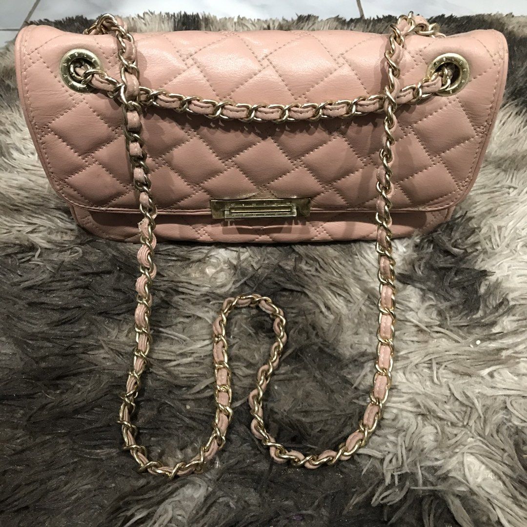 Sisley Pink Quilted Chain Shoulder Bag (Category: Shoulder Bags) located in Manila. Submitted by happyocean_97f34c (Listing ID 1449153680, Image 2). Description: condition 7/10 leather aging and gold hairline - Pink quilted shoulder bag from Sisley - Features a stylish gold chain strap - Secure front clasp closure - Interior includes multiple compartments and a zip pocket - Versatile for everyday use or evening outings - Interior is clean - Minor