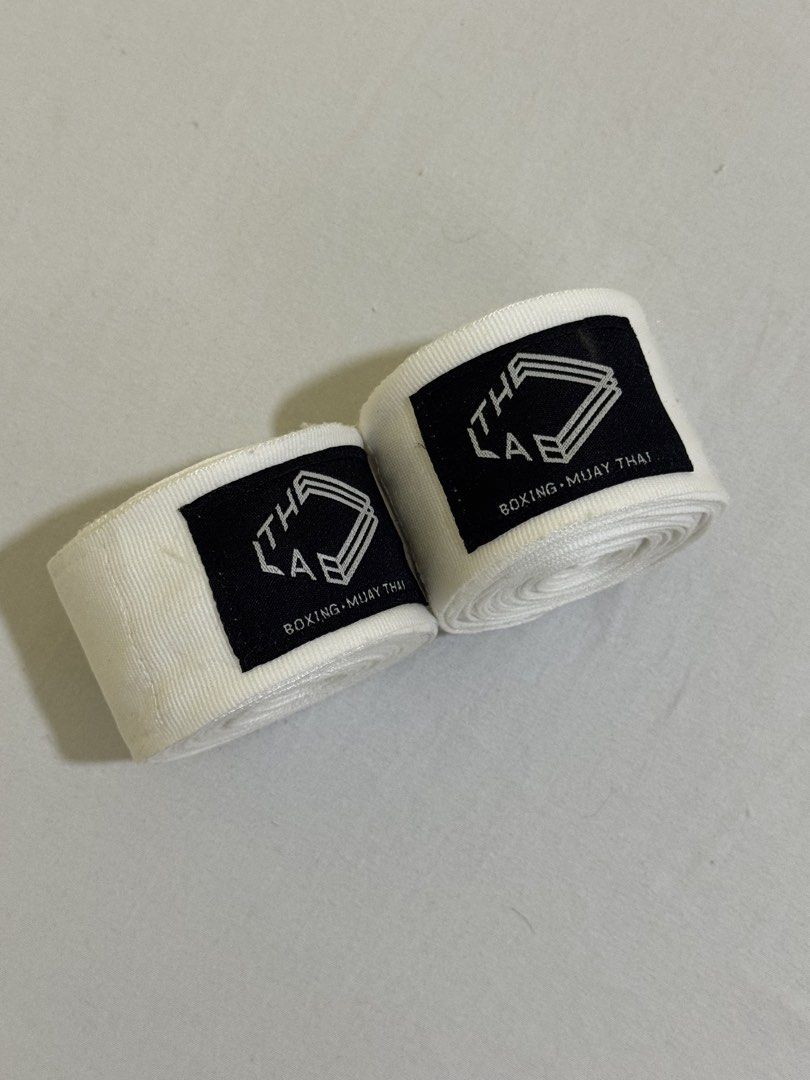 The Lab Boxing Muay Thai Hand Wraps White (Category: Combat Sports) located in Mandaluyong City. Submitted by joanne7a (Listing ID 1449175022, Image 2). Description: - Brand: The Lab - Color: White - Ideal for: Boxing, Muay Thai training - Closure: Secure velcro - Length: Standard - Benefits: Protects hands during sparring and bag work - RFS: not using anymore Barely used.