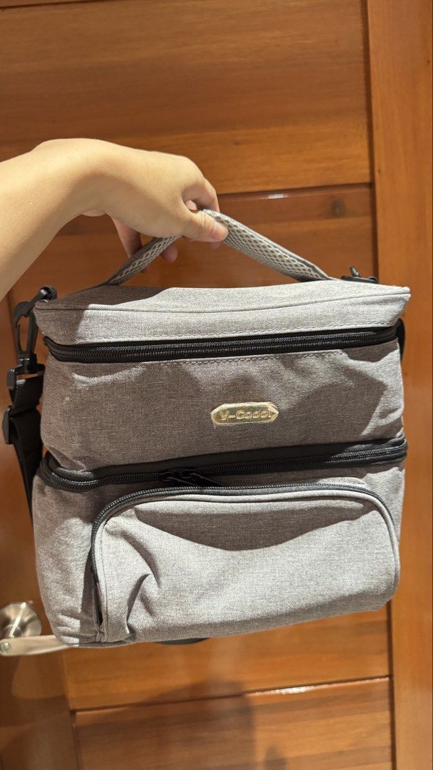 V-Coool Insulated Cooler Bag with Compartments (Category: Breastfeeding & Bottle Feeding) located in Manila. Submitted by sabgonzaga (Listing ID 1449144162, Image 1). Description: - Grey V-Coool cooler bag - Two main zippered compartments - Top compartment with internal mesh pockets - Spacious bottom compartment for food/drinks - Detachable shoulder strap included - Separate zippered pouch for accessories - Ideal for outings and travel Used once 