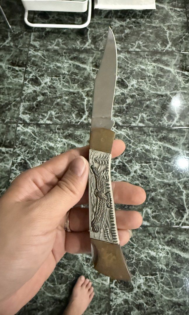 Vintage Eagle Folding Pocket Knife (Category: Vintage Collectibles) located in Kuala Lumpur. Submitted by nojoybidderpls (Listing ID 1449231966, Image 3). Description: - Cool vintage pocket knife - Features an eagle design on the handle - Blade opens and closes smoothly - Brass accents - Great for collectors or everyday carry (EDC) - Small pink sticker on the handle.