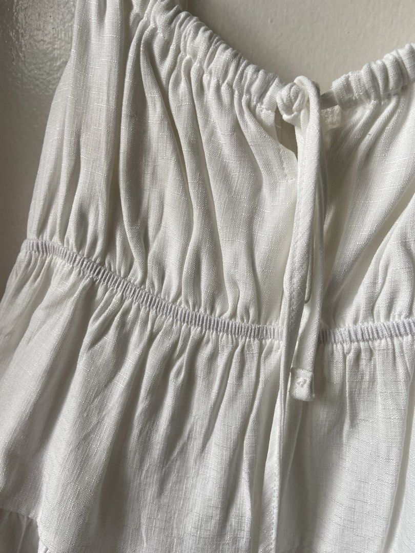 White Tiered Tie-Strap Cami Top (Category: Sleeveless) located in Manila. Submitted by cosmic.ph (Listing ID 1449203514, Image 3). Description: White cami top from ROMWE Tiered design with smocked bust detailing Adjustable tie straps for a custom fit Versatile for layering or wearing on its own Size S on tag but can honestly fit up to M Only used once! No flaws, good as new!! DM for more info!! <3.