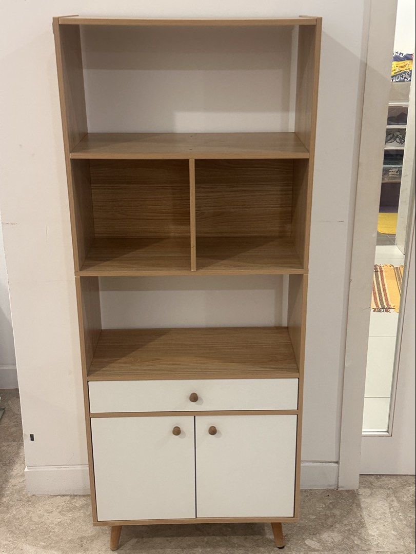 Wooden Bookshelf with Cabinet and Drawer (Category: Shelves, Cabinets & Racks) located in Kuala Lumpur. Submitted by shahshams (Listing ID 1449238862, Image 1). Description: Sell because moving Available for pick up now - Tall bookshelf with a mix of open shelves and a bottom cabinet. - Features one drawer above the cabinet doors. - Wood grain finish on shelves and frame. - White cabinet doors and drawer front for a modern look. - Stands on four 