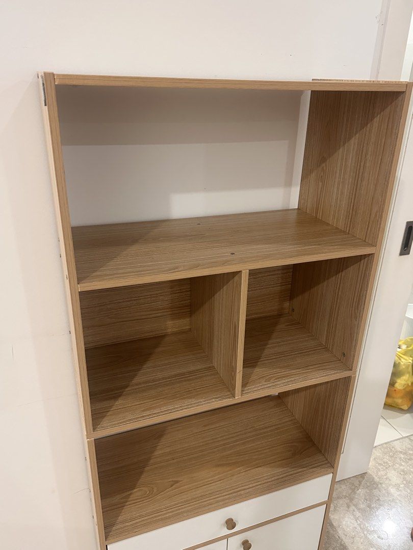Wooden Bookshelf with Cabinet and Drawer (Category: Shelves, Cabinets & Racks) located in Kuala Lumpur. Submitted by shahshams (Listing ID 1449238862, Image 2). Description: Sell because moving Available for pick up now - Tall bookshelf with a mix of open shelves and a bottom cabinet. - Features one drawer above the cabinet doors. - Wood grain finish on shelves and frame. - White cabinet doors and drawer front for a modern look. - Stands on four 