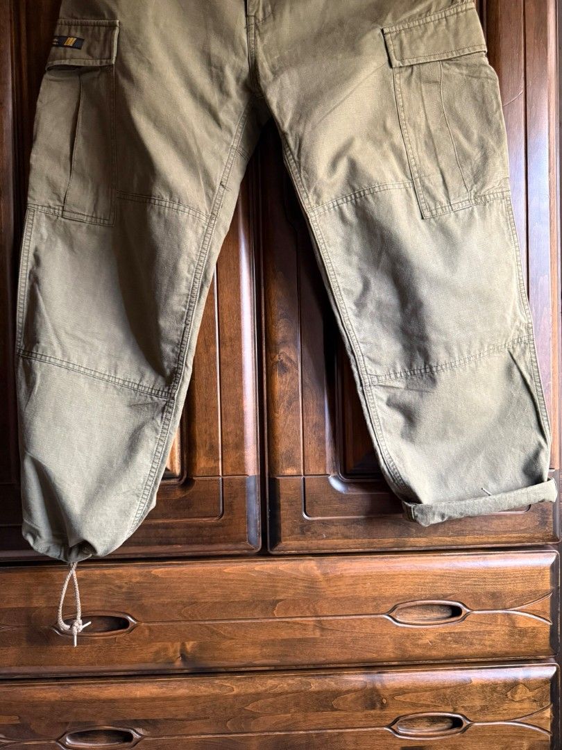 WTAPS Cargo Fatigue Pants Olive Green (Category: Trousers) located in Cabatuan. Submitted by kulas799 (Listing ID 1449198314, Image 3). Description: - WTAPS Military Cargo Fatigue Pants - Color: Olive Green - Size: Tagged M - Material: Durable Cotton - Features: Multiple pockets, ankle drawstrings - Style: Ideal for casual wear waist 16.5 (32-33) overall length 40 leg opening 8.5.