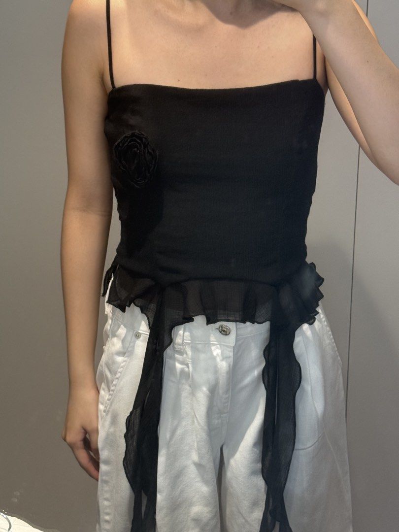 Zara Black Top with Ruffle Detail (Category: Sleeveless) located in Quezon City. Submitted by ak3isha (Listing ID 1449196496, Image 2). Description: - Adjustable Strap - Rose detail on bust - Ruffled, flowy hem with long sheer fabric strips.