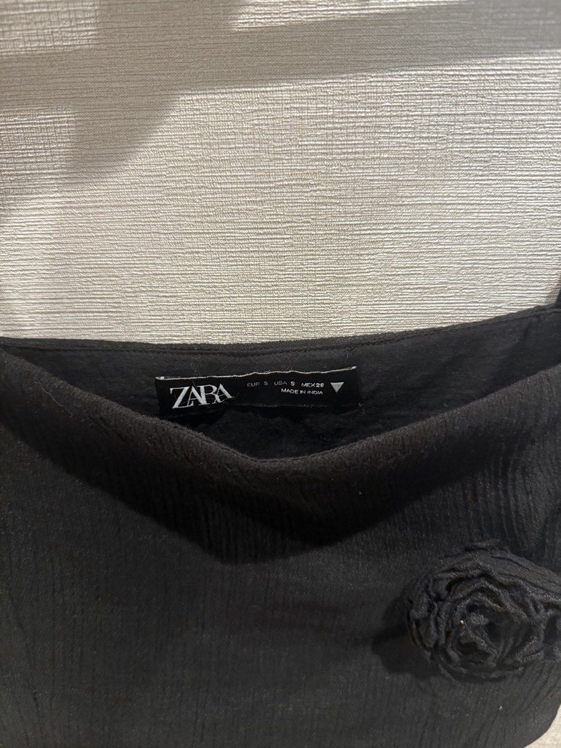 Zara Black Top with Ruffle Detail (Category: Sleeveless) located in Quezon City. Submitted by ak3isha (Listing ID 1449196496, Image 3). Description: - Adjustable Strap - Rose detail on bust - Ruffled, flowy hem with long sheer fabric strips.