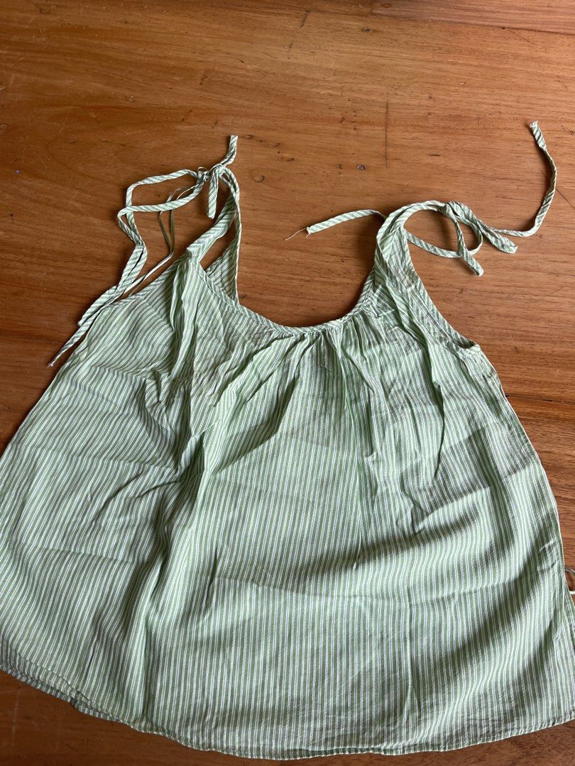 Zara Green Striped Tie Strap Tank Top (Category: Sleeveless) located in Makati City. Submitted by jmieiii (Listing ID 1449139093, Image 2). Description: - Cute Zara tank top - Green and white stripes - Tie straps on shoulders - Lightweight and breezy material - Perfect for summer - Easy to style with shorts or jeans.