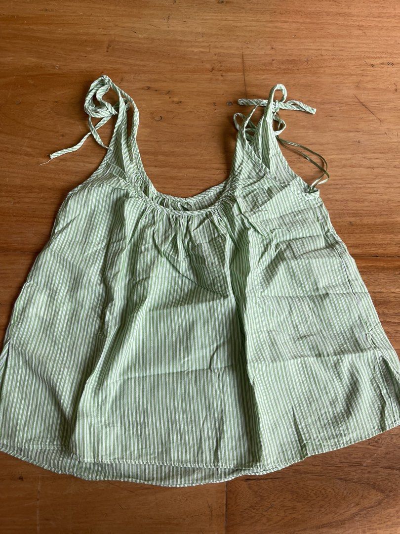 Zara Green Striped Tie Strap Tank Top (Category: Sleeveless) located in Makati City. Submitted by jmieiii (Listing ID 1449139093, Image 1). Description: - Cute Zara tank top - Green and white stripes - Tie straps on shoulders - Lightweight and breezy material - Perfect for summer - Easy to style with shorts or jeans.