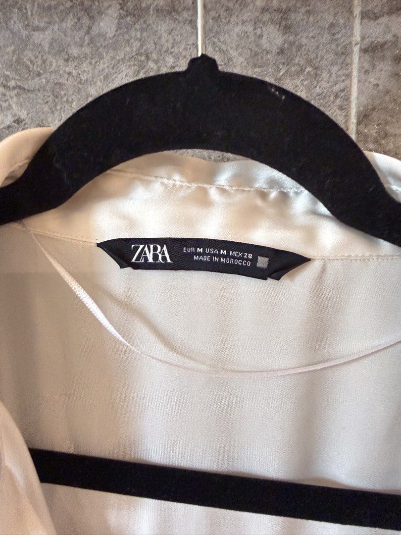 Zara Satin Button-Up Shirt (Category: Shirts) located in Taguig. Submitted by acappaca2 (Listing ID 1449152634, Image 2). Description: - Zara cream satin shirt - Long sleeves with button cuffs - Classic collar and button front - Versatile for dressing up or down.