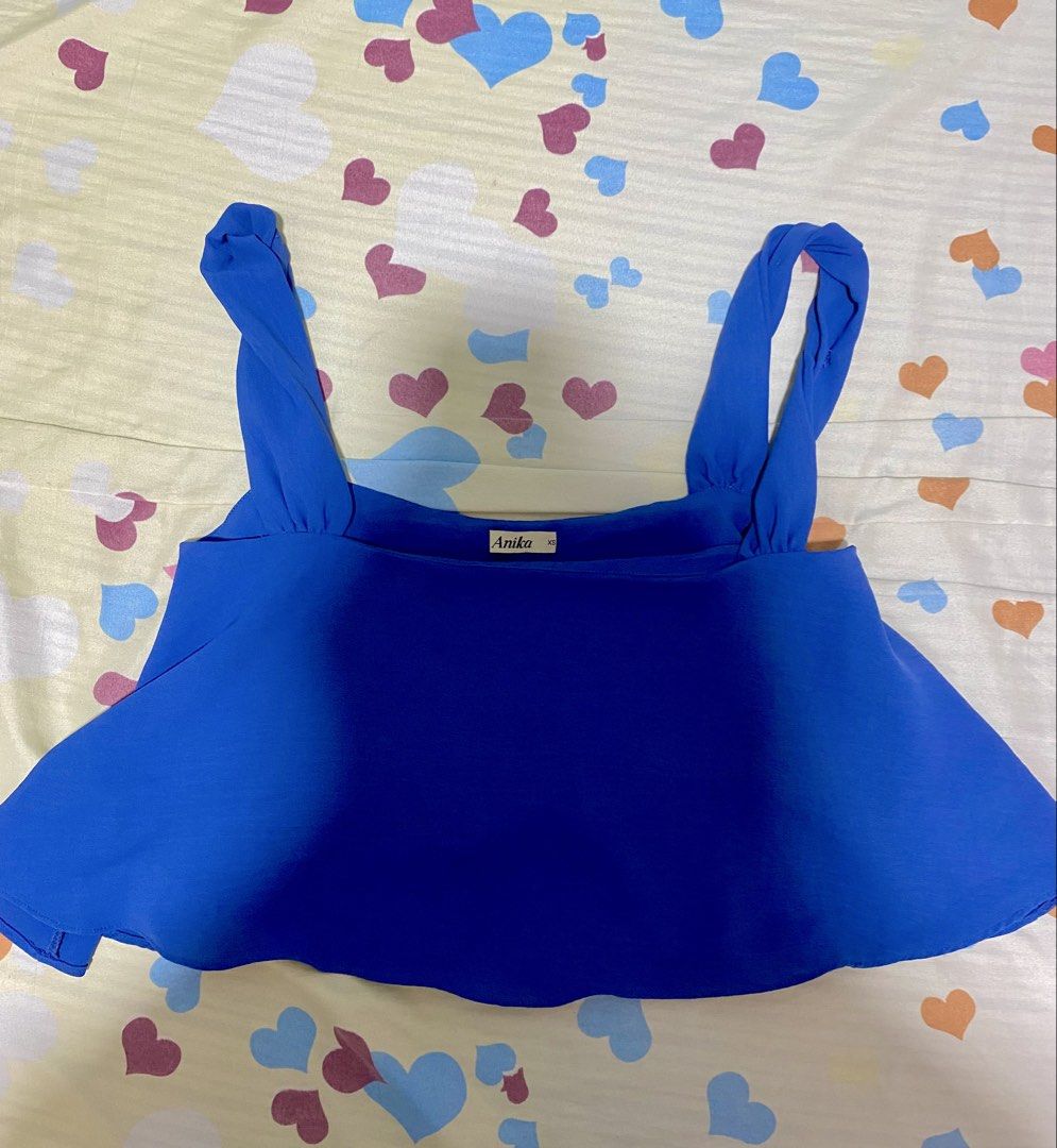 Anika Blue Cropped Tank Top XS (Category: Sleeveless) located in Manila. Submitted by vickim0513 (Listing ID 1449453489, Image 1). Description: - Brand: Anika - Color: Blue - Style: Cropped Tank Top - Neckline: Square - Straps: Tie - Hem: Flared - Estimated Size: XS - Occasion: Casual wear or dressing up.
