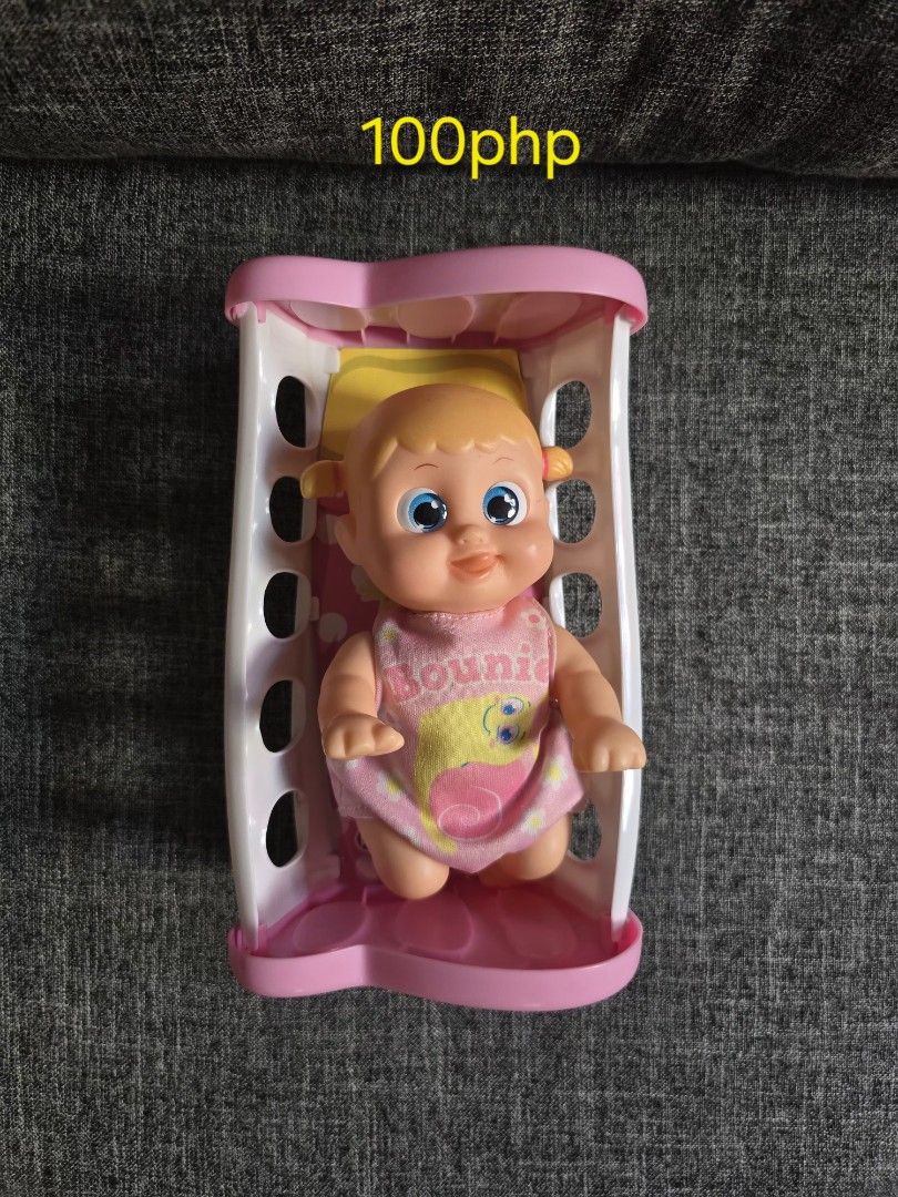 Baby Doll with Crib and Accessories (Category: Kids Toys) located in Quezon City. Submitted by bon00 (Listing ID 1449460806, Image 1). Description: Cute baby doll set. Includes a pink and white crib. Doll has big blue eyes and wears a pink outfit. Also comes with a pink outfit and hat, and a bubble accessory. Great for playtime..