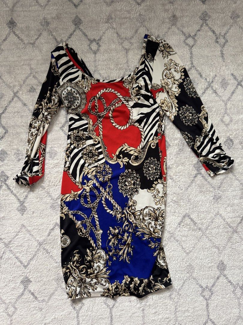 Baroque Print Long Sleeve Mini Dress (Category: Dresses) located in Manila. Submitted by chaz16 (Listing ID 1449380820, Image 1). Description: - Bold baroque print mini dress - Features red, blue, black, white, and zebra patterns - Accented with gold chain details - Long sleeves with ruffled cuffs - Flattering bodycon fit - Ideal statement piece for a night out.