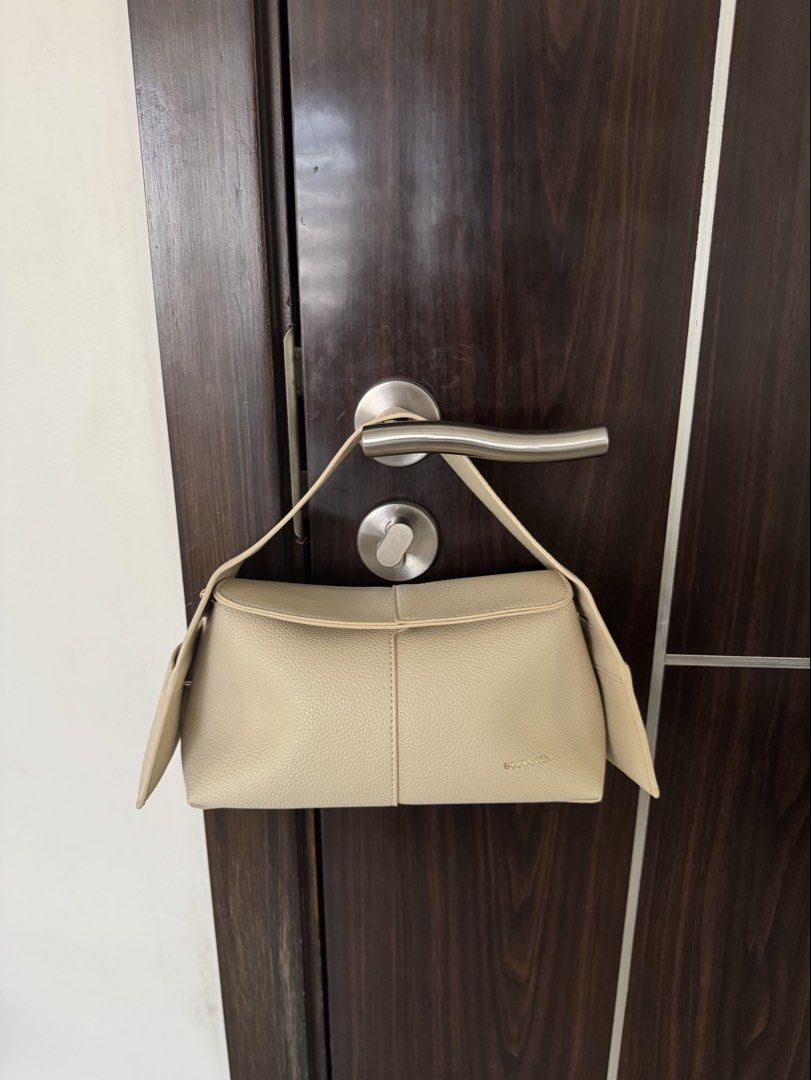BEIGE LEATHER SHOULDER BAG (Category: Shoulder Bags) located in Manila. Submitted by declutterzoneee (Listing ID 1449384350, Image 1). Description: - Beige leather shoulder bag - Textured finish - Magnetic closure - Convenient back pocket - Elegant gold hardware details - Compact size: Approx. 9 inches long x 4 inches tall - Ideal for everyday use.