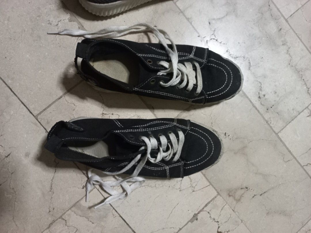 Black Canvas Sneakers with White Laces (Category: Sneakers) located in Quezon City. Submitted by msdcshop (Listing ID 1449532347, Image 1). Description: - Black canvas low-top sneakers - White stitching and white laces - White soles with visible signs of wear - Ideal for casual everyday wear - still nice no flaws needs cleaning only - Features a unique textured sole pattern.