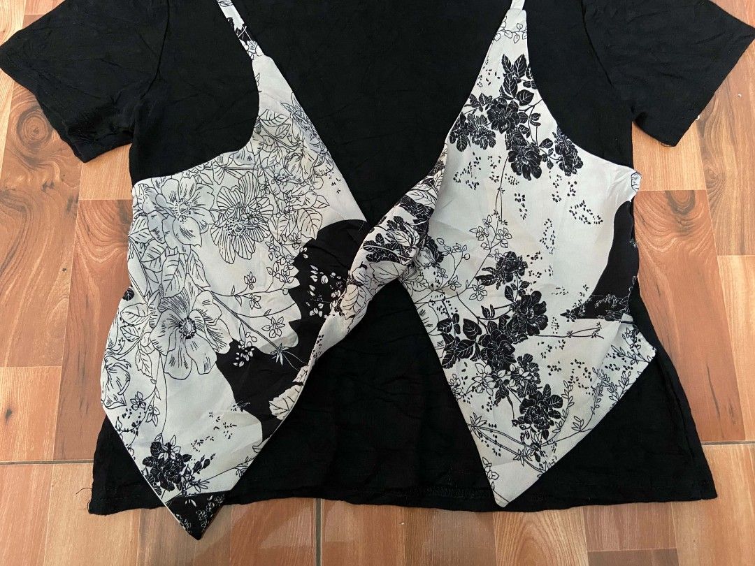 Black T-shirt with Floral Overlay Design (Category: Tshirts & Polo Shirts ) located in Nabua. Submitted by chic-rack (Listing ID 1449417607, Image 2). Description: - Black short-sleeved t-shirt - Unique floral print overlay in light grey and black - Creates a stylish layered top illusion - Versatile for casual or edgy looks - Easy to pair with different outfits - Price+SF.