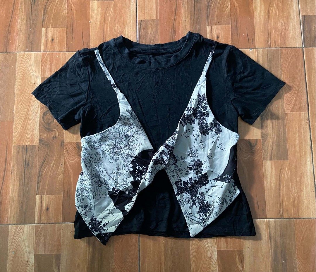 Black T-shirt with Floral Overlay Design (Category: Tshirts & Polo Shirts ) located in Nabua. Submitted by chic-rack (Listing ID 1449417607, Image 1). Description: - Black short-sleeved t-shirt - Unique floral print overlay in light grey and black - Creates a stylish layered top illusion - Versatile for casual or edgy looks - Easy to pair with different outfits - Price+SF.