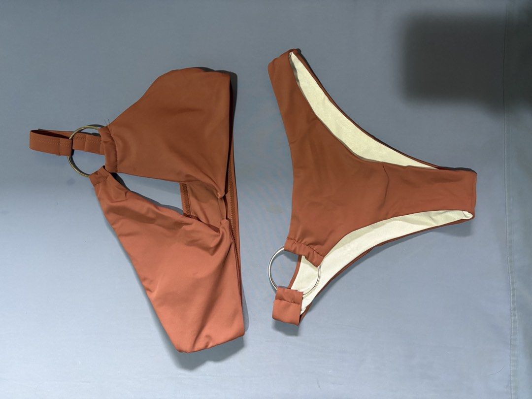 Brown Ring Detail One Shoulder Bikini Set (Category: Bikinis & Swimsuits) located in Quezon City. Submitted by ela___ (Listing ID 1449348122, Image 1). Description: - Cute brown bikini set - Top: One-shoulder design with ring detail - Bottoms: High-cut style with ring detail - Perfect for beach trips or pool days - Selling as a complete set.
