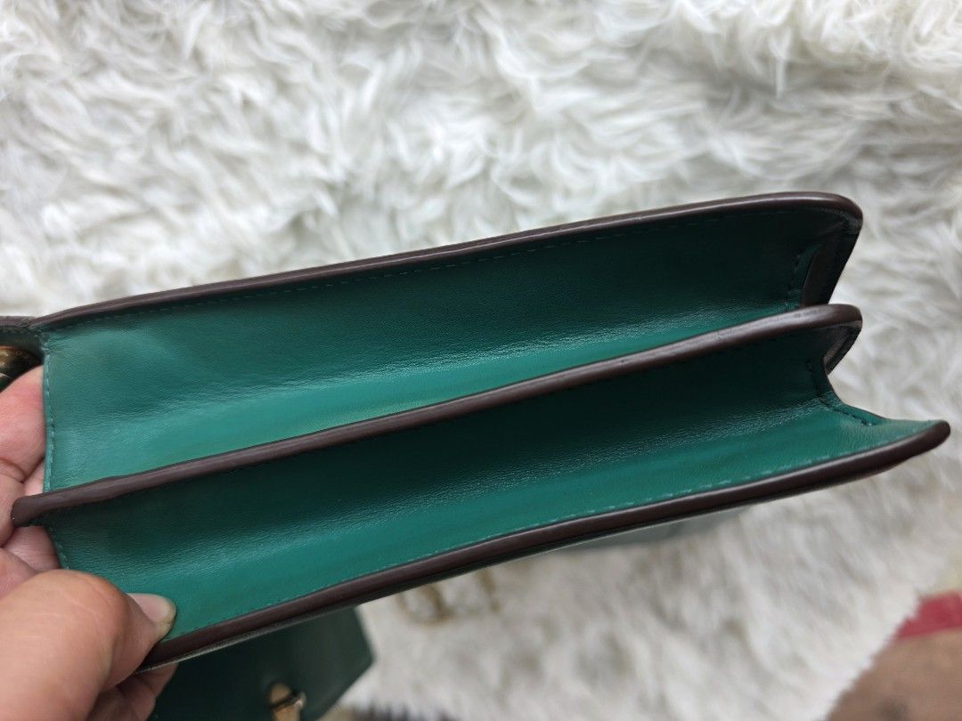 Bulgari Emerald Green Leather Chain Shoulder Bag (Category: Luxury Bags & Wallets) located in Lemery. Submitted by venus23 (Listing ID 1449343547, Image 3). Description: - Bulgari shoulder bag - Stunning emerald green leather - Iconic Bulgari snake clasp - Elegant gold chain strap - Multiple interior compartments - Made in Italy - Good overall condition with minor scuffs on leather.