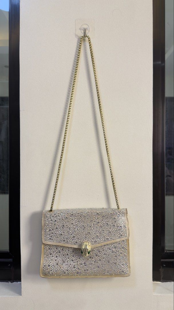 BVLGARI Serpenti Embellished Shoulder Bag (Category: Luxury Bags & Wallets) located in Paranaque City. Submitted by mykapoynton (Listing ID 1449519632, Image 1). Description: BVLGARI Serpenti Embellished Shoulder Bag - Iconic BVLGARI snake clasp - Gold chain strap - Clean interior with zippered pocket - Made in Italy - Ideal for nights out or special occasions.