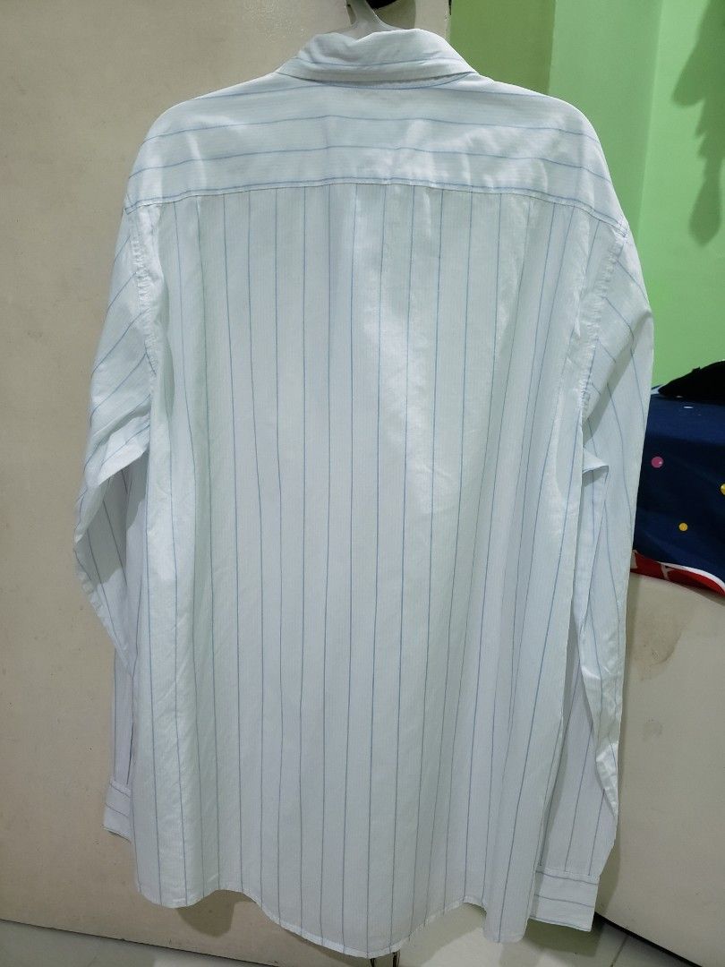 Calvin Klein Long sleeve polo vertical blue stripe (Category: Tshirts & Polo Shirts ) located in Navotas City. Submitted by miloklo (Listing ID 1449447549, Image 2). Description: - Calvin Klein Long sleeve polo - Size: Medium - Shoulder: 18.5 inches - Chest: 23 inches - Bottom Hem: 22.5 inches - Sleeve Length: 26 inches - Length: 30.5 inches - Features thin vetical blue stripes - Calvin Klein Jeans branding - Collared style with front buttons.