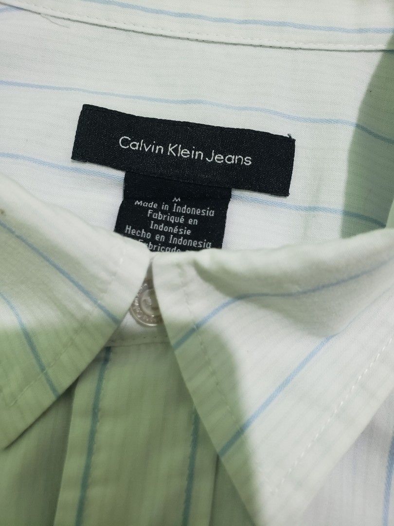 Calvin Klein Long sleeve polo vertical blue stripe (Category: Tshirts & Polo Shirts ) located in Navotas City. Submitted by miloklo (Listing ID 1449447549, Image 3). Description: - Calvin Klein Long sleeve polo - Size: Medium - Shoulder: 18.5 inches - Chest: 23 inches - Bottom Hem: 22.5 inches - Sleeve Length: 26 inches - Length: 30.5 inches - Features thin vetical blue stripes - Calvin Klein Jeans branding - Collared style with front buttons.