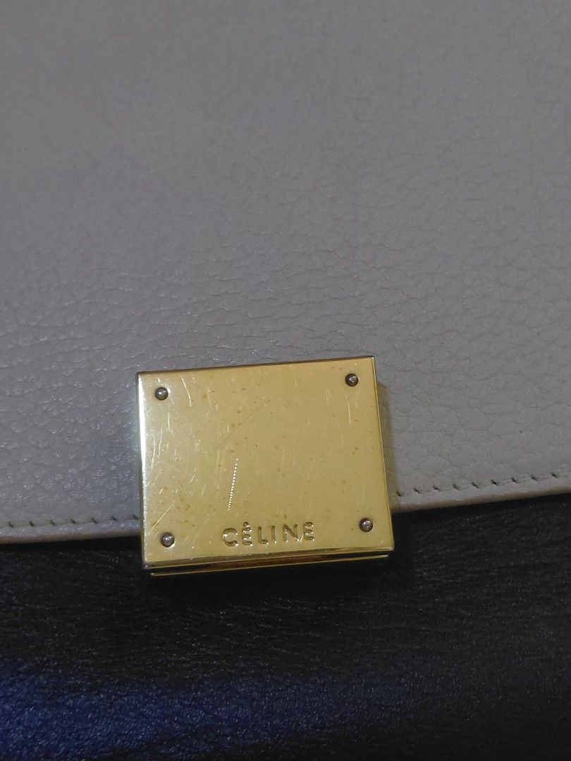 Celine Trapeze (Category: Luxury Bags & Wallets) located in Pasig City. Submitted by redellie (Listing ID 1449414531, Image 3). Description: Brand/Model: Celine Trapeze. Colorway: Tricolor (Beige/Gray, Black, and potentially Red or Burnt Orange sides). Material: Smooth calfskin leather. Features: Iconic top handle, expanding accordion wings, and a clasp closure. Inclusion: strap only and auth card.