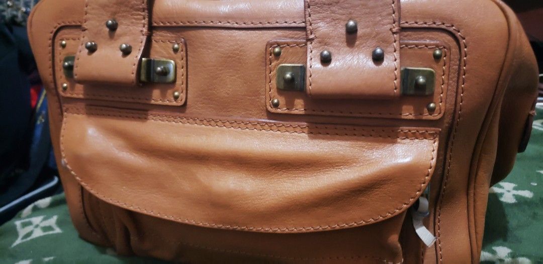 Chloe Leather Handbag (Category: Luxury Bags & Wallets) located in Marikina City. Submitted by racoon143 (Listing ID 1449434209, Image 2). Description: - Authentic brown leather Chloe handbag - Signature Chloe hardware and flap pocket - Convenient top handles - Secure zipper closure - Spacious interior, ideal for everyday essentials - Shows some signs of wear, but remains in good overall condition.