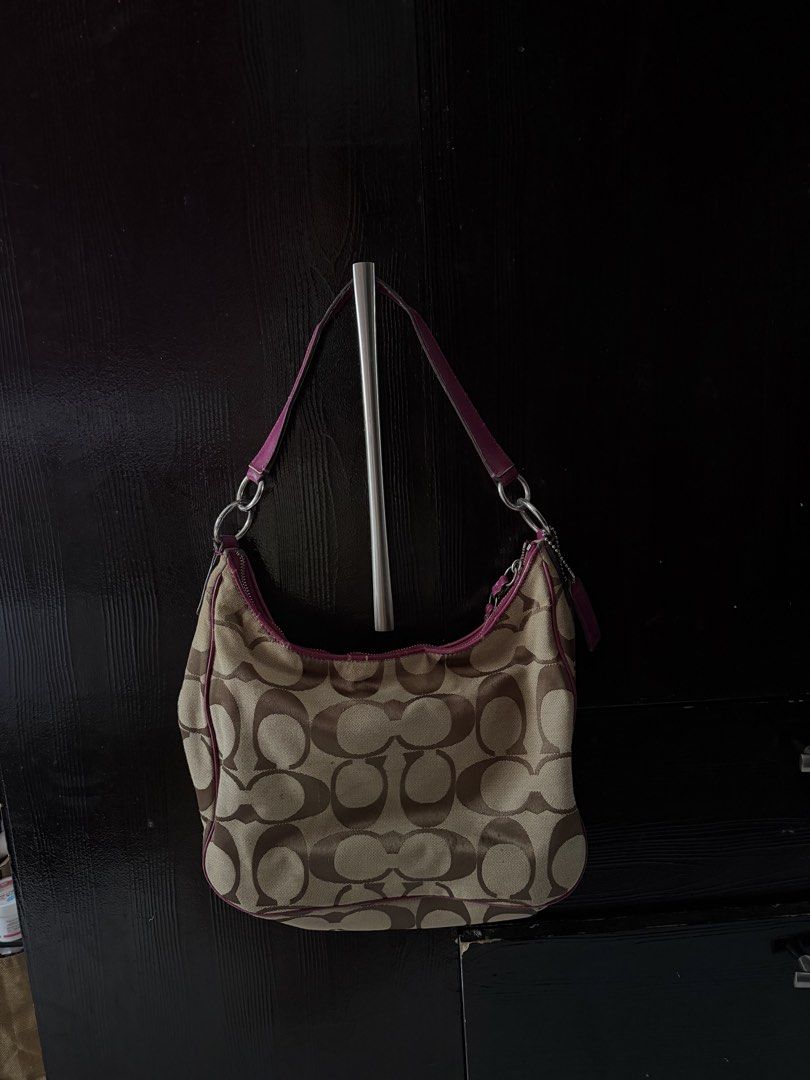 Preloved Coach Monogram Canvas & Leather Shoulder Bag (Category: Luxury Bags & Wallets) located in Lipa City. Submitted by xynami (Listing ID 1449412035, Image 2). Description: - Authentic Coach Hobo Bag see tag last slide issues of use - Classic monogram canvas with magenta leather accents - Silver hardware - Interior zip and slip pockets - Spacious for essentials - Ideal everyday bag - Includes two Coach hang tags.