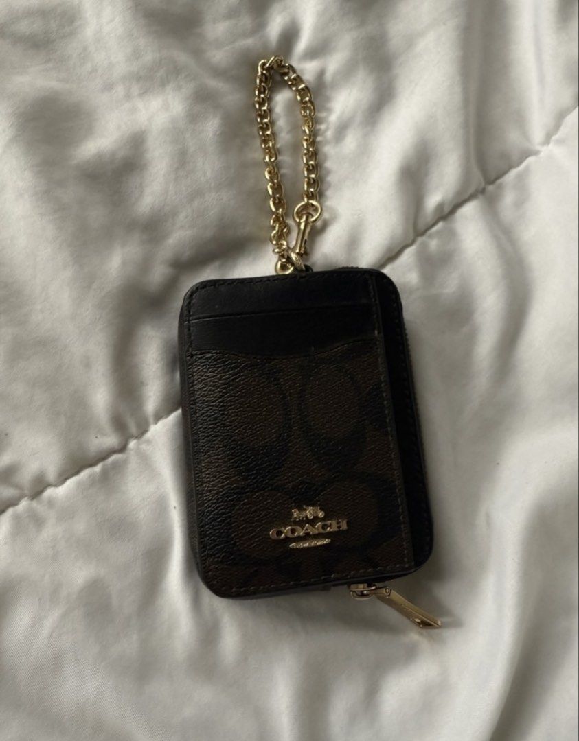 Coach Wallet (Category: Luxury Bags & Wallets) located in Batangas. Submitted by gaprelovedthings (Listing ID 1449434398, Image 1). Description: - Authentic Coach cardholder - Signature C print in brown and black - Zippered compartment for coins or folded bills - Multiple card slots on the front - Detachable gold chain strap - Ideal for organizing essentials like cards and cash.